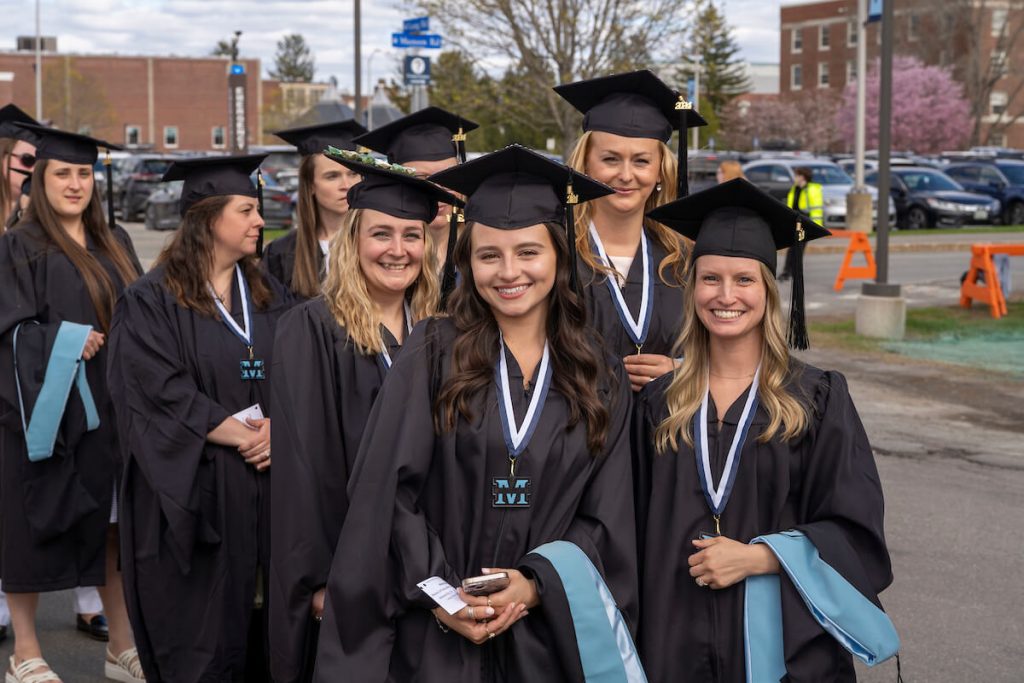A photo of graduate students walking to the Alfond Arena