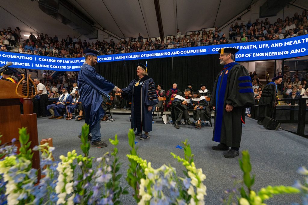 A photo of a student walking across the stage