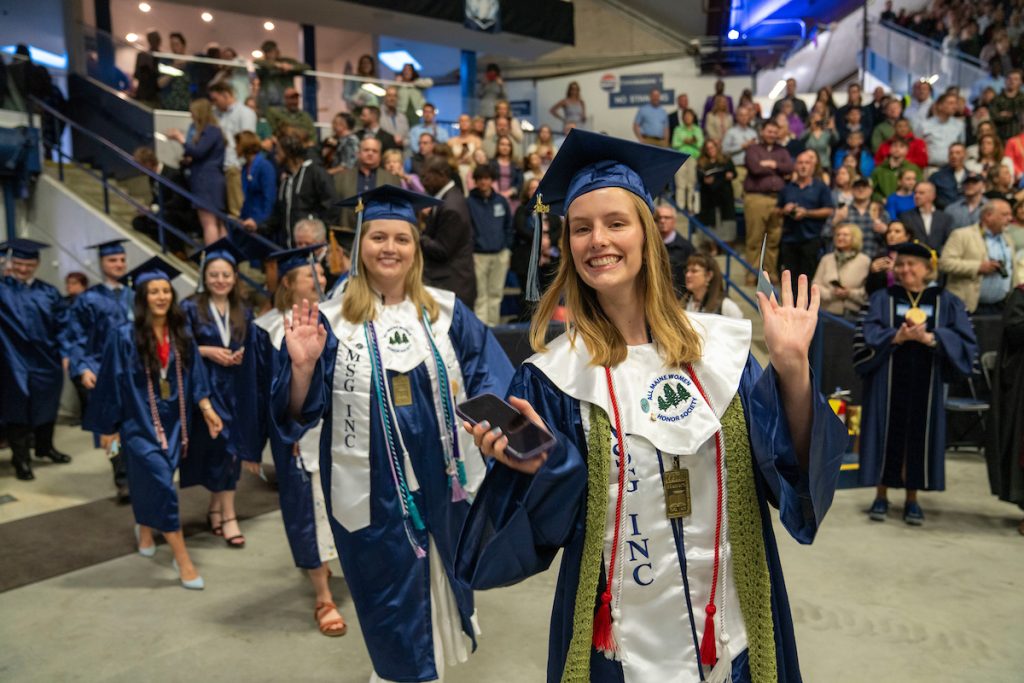 A photo of waving graduates