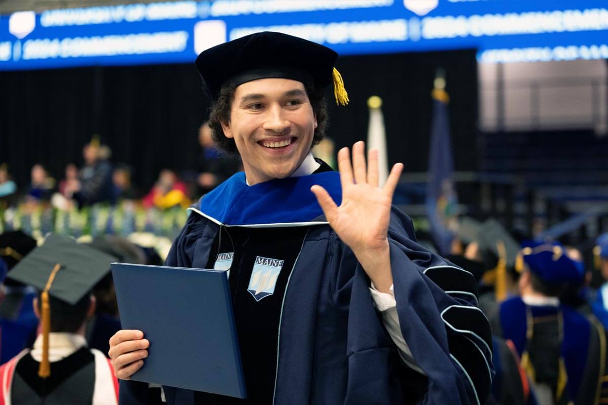 A photo of a graduate holding a diploma