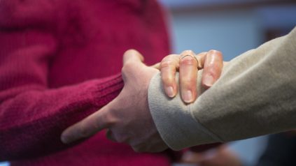 Elderly woman hold hand with man