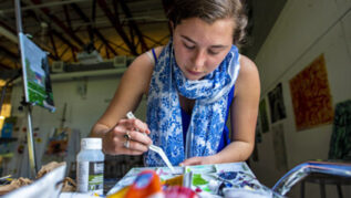 Female student painting in an art studio